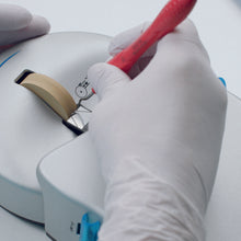 LM-RondoPlus™ Sharpening Machine. Image showing how to hold a stainless steel instrument against the sharpening wheel.